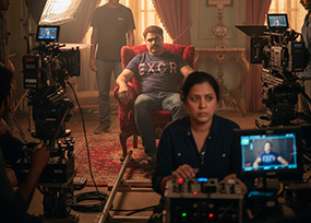 Cinematographer shooting documentary visuals outdoors